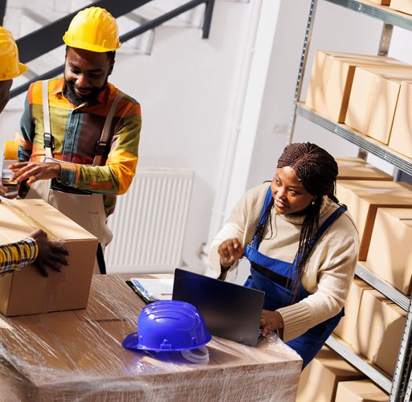 warehouse-manager-checking-orders-list-coordinating-parcels-packing-process-african-american-woman-supervisor-with-laptop-controlling-freight-cardboard-boxes-sealing-dispatching